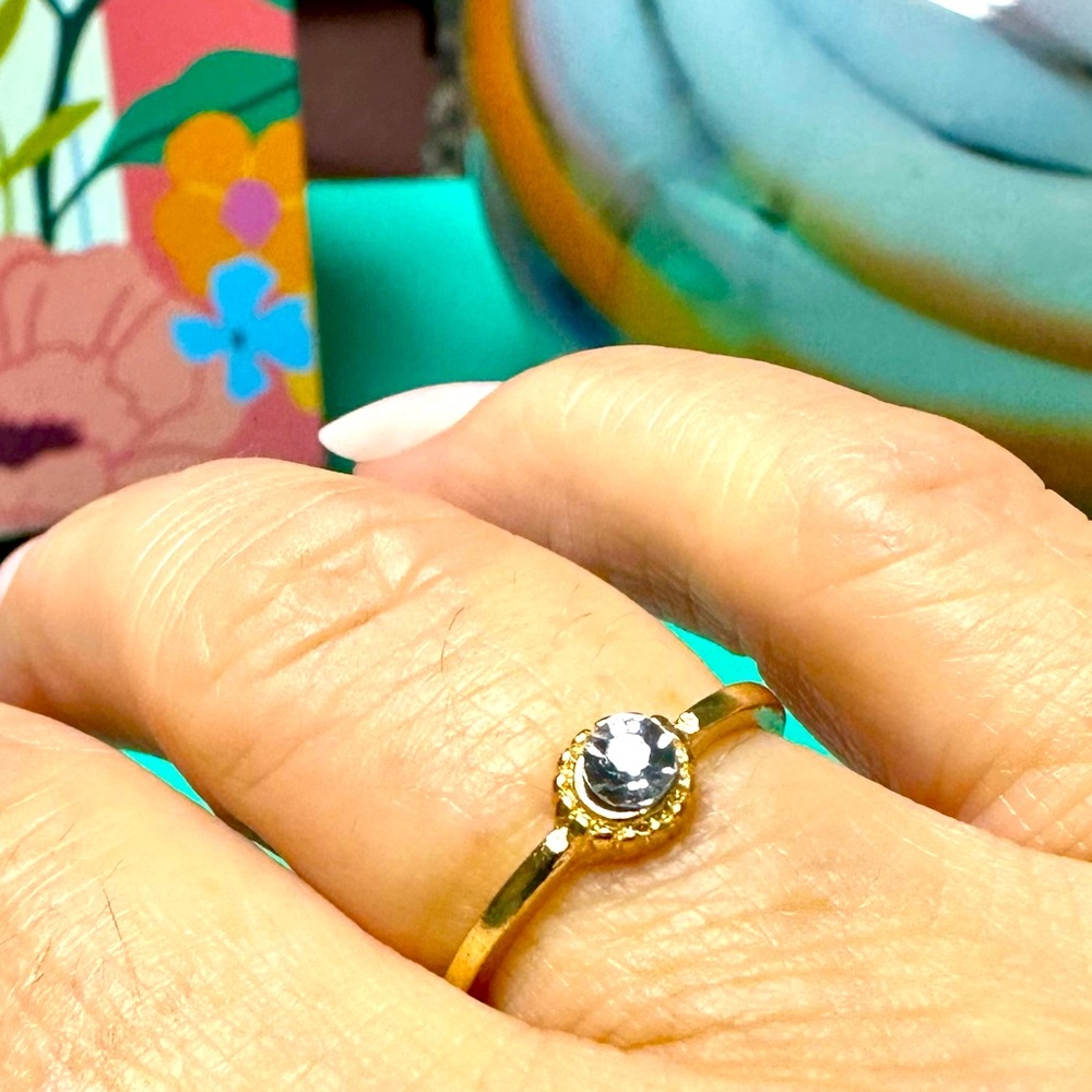 Delicate gold tone ring, and gemstone size 7